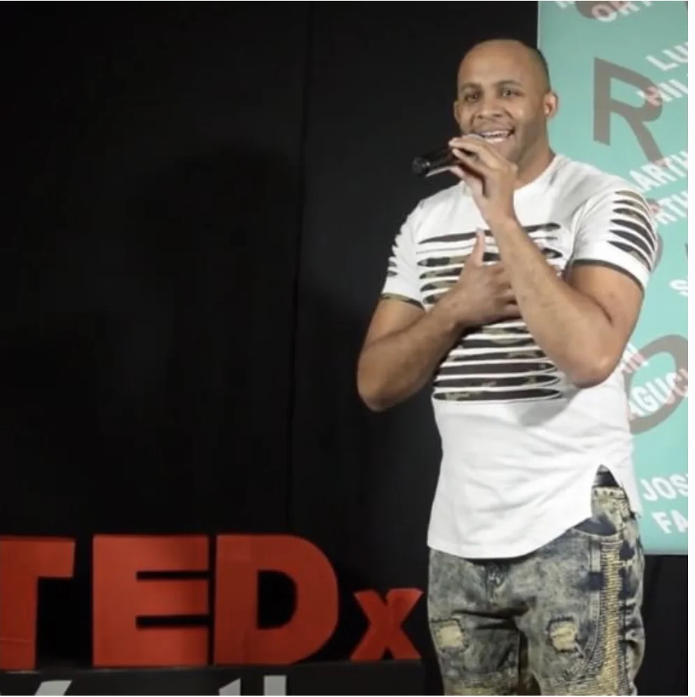 Cauveé speaking on a TEDx stage